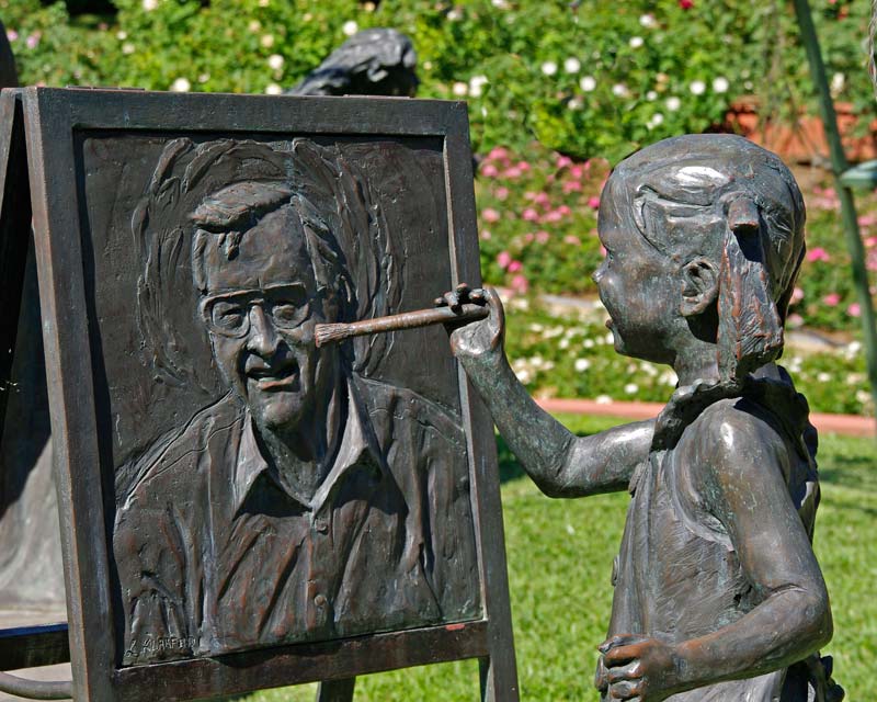 Sculpture of a child painting the Garden's creator Bill Roche in centre of Rose Garden - Hunter Valley Gardens
