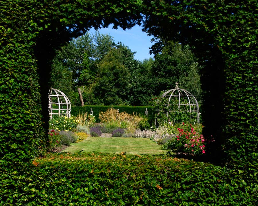 The Rose Garden viewed through windows in the Yew Hedge