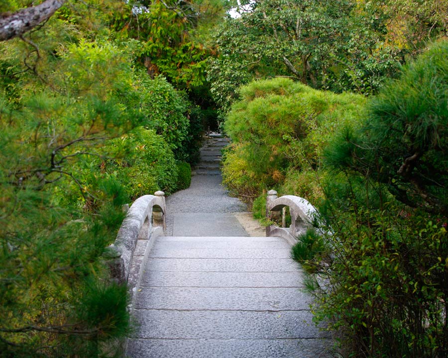Ryoanji Zen Rock Garden, Kyoto Small stone bridge over the water to the shrine