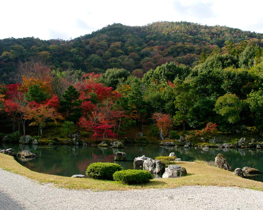 Sogenichi Pond - Tenryu-ji Temple Gardens. 3 plains, sand, pond and rocks with Mount Arashi in the distance