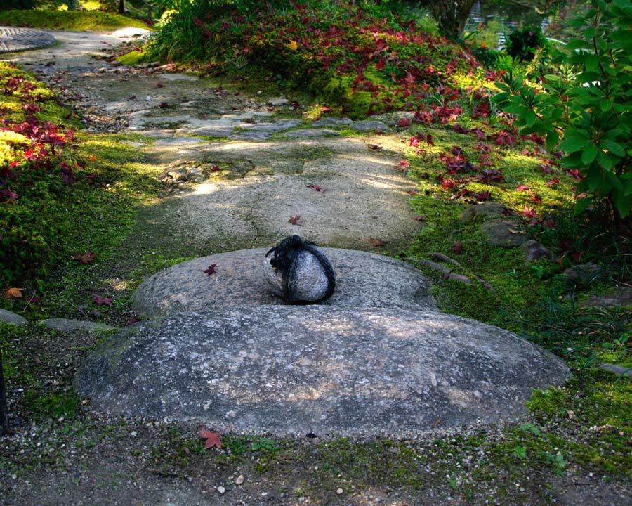 Isuien Garden - Rock tied with string placed in paths to show that the path is closed and entry not permitted