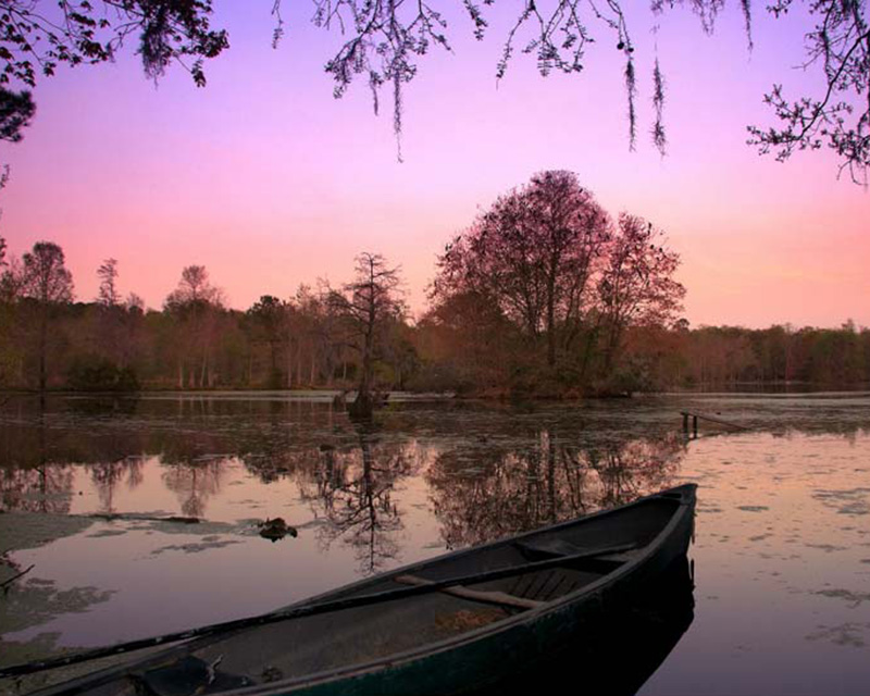 Sunset over the water photos supplied by Magnolia Plantation and Gardens